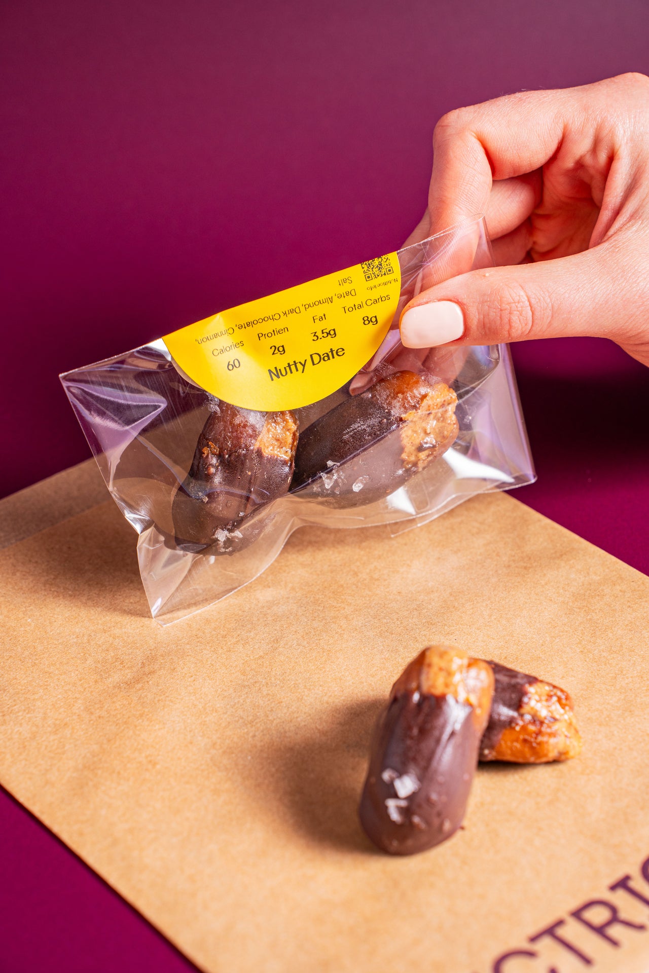 Nutty Date (2-Pack); Baked & Sweets, Snacks; Dates, Almonds, Chocolate (Coconut Sugar), Cinnamon, Salt; Contains Tree Nuts; A sweet date, a nutty squeeze, and a chocolatey hug.
